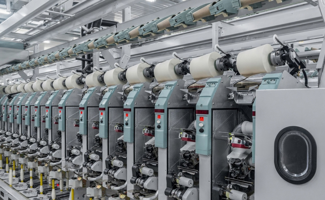 Auto cone winding machines creating uniform yarn cones.