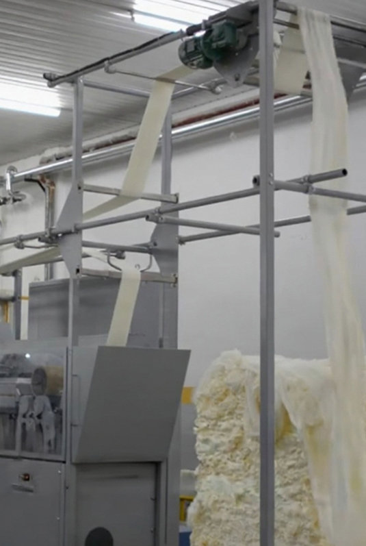Stretch breaker machines processing fiber slivers in a clean, well-lit spinning facility