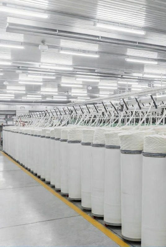 Technician monitoring simplex machine while slivers wind onto bobbins