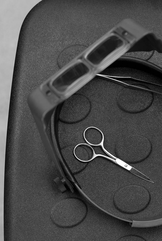 Technician inspecting woven fabric on a light table for quality consistency
