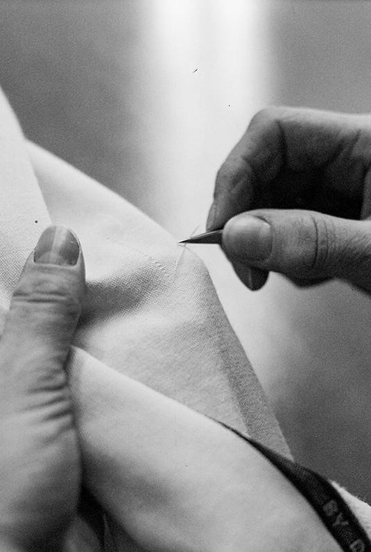 Labeled rolls of fabric marked as quality checked in inspection area