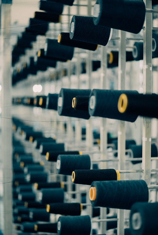 Close-up of yarns being wound onto a warp beam